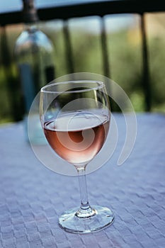Enjoying a glass of rose wine on the veranda, summer holiday in Italy