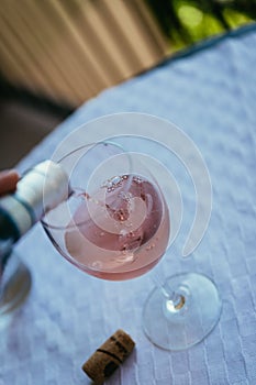 Enjoying a glass of rose wine on the veranda, summer holiday in Italy