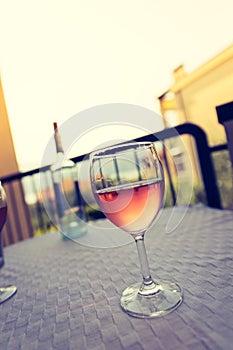 Enjoying a glass of rose wine on the veranda, summer holiday in Italy