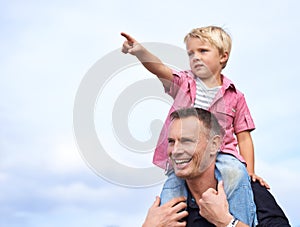 Enjoying his dad with dad. A handsome father carrying his son on his shoulders.