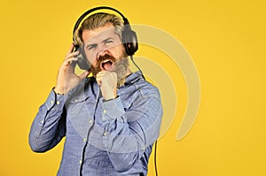 Enjoying his favorite music. Man listening music with his headphones. bearded man hipster in headset. Listening to music