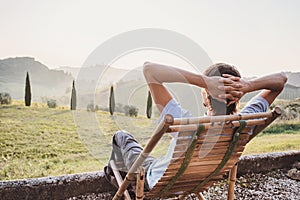 Enjoying life. Young man looking at the valley in Italy, relaxation, vacations, lifestyle concept