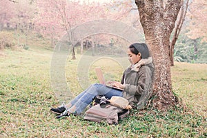 Enjoying moment woman backpacker using laptop in beautiful forest background