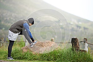 Enjoying a morning jog. Full length of a young jogger stretching in the morning and admiring the view.