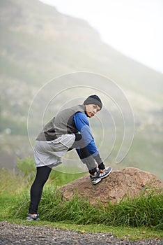 Enjoying a morning jog. A young man tying his shoe laces before a morning run in winter.