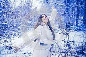 Enjoying nature wintertime. Vintage winter person. Girl playing with snow in park. Beautiful young woman laughing