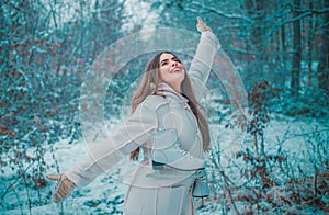 Enjoying nature wintertime. Vintage winter person. Girl playing with snow in park. Beautiful young woman laughing