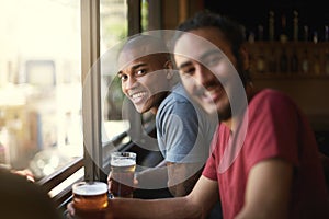 Enjoying a pint with his mates. Portrait of two friends enjoying themselves in the pub.