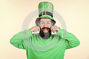 Enjoying the prefect mustache. Irish man with beard twirling mustache in green wear. Bearded man celebrating saint
