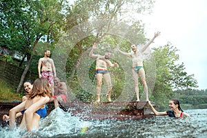 Enjoying river party with friends. Group of beautiful happy young people at the river together