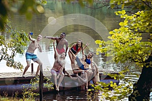 Enjoying river party with friends. Group of beautiful happy young people at the river together