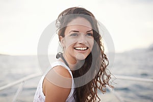 Enjoying a summer sail. Portrait of an attractive young woman enjoying a boat ride on the lake.