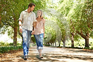 Enjoying a summer walkabout. Shot of a mature couple enjoying a walk in the park.