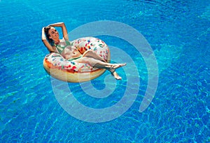 Enjoying suntan Woman in bikini on the inflatable mattress