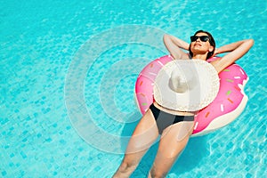 Enjoying suntan woman in bikini on the inflatable mattress