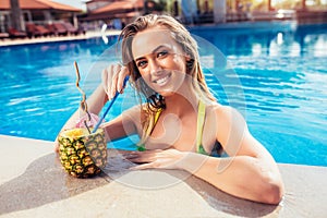 Enjoying suntan Woman in bikini in the swimming pool