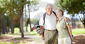 Enjoying their day of golf together. Portrait of a senior couple laughing and smiling during a round of golf together.
