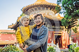 Enjoying vacation in China. Dad and son in Forbidden City. Travel to China with kids concept. Visa free transit 72 hours