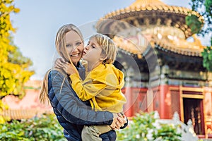 Enjoying vacation in China. Mom and son in Forbidden City. Travel to China with kids concept. Visa free transit 72 hours