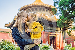 Enjoying vacation in China. Mom and son in Forbidden City. Travel to China with kids concept. Visa free transit 72 hours