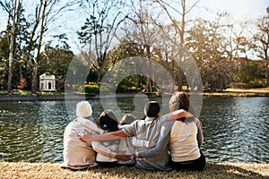 Enjoying the view of the lake together. Rearview shot of a family spending time together outdoors.