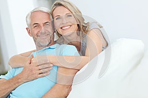 Enjoying the weekend together. Portrait of a happy mature couple relaxing at home.