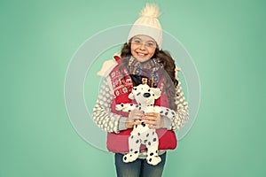 Enjoying winter holidays together. small girl hold dog toy. kid love her fluffy pet puppy. winter activity and fun