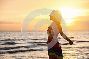 Enjoyment - free happy woman enjoying sunset.