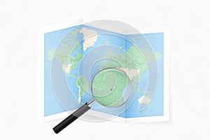 Enlarge Burundi with a magnifying glass on a folded map of the world