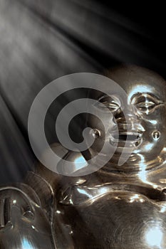 Enlightened Buddha. Brass statue of enlightened laughing monk. photo