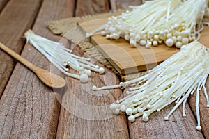 Enoki mushroom with spoon on wooden table