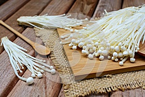 Enoki mushroom with spoon on wooden table