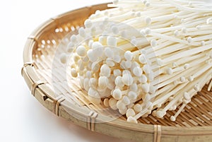 Enoki mushrooms on a white background