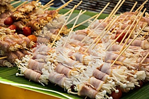 Enoki mushrooms wrapped with pork bacon, prepared for barbeque