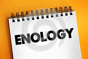 Enology is the science and study of wine and winemaking, text concept on notepad