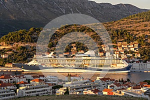 Enormous cruise at Dubrovnik port in sunset in Croatia summer