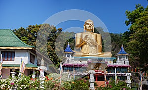 Giant Gold Buddha Sculpture at Dambulla Cave Temple in Sri Lanka photo