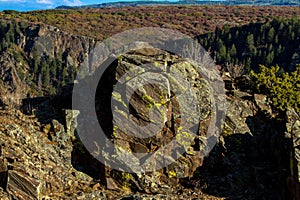 Enormous moss-rock boulder on the top edge of Black Canyon of the Gunnison National Park in Colorado