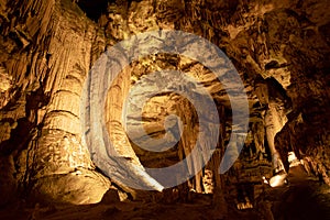 Enormous pillars and rock formations inside underground cave cavern