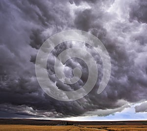 Enormous storm cloud above an field