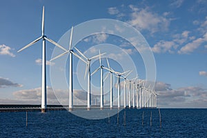 Enormous windmills standing in the sea photo