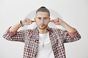 Enough of your excuses, I am done with you. Portrait of angry or annoyed young man with beard, wearing trendy glasses