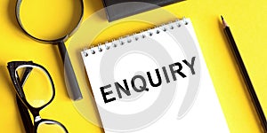 ENQUIRY word written on notepad. ENQUIRY text on table for your desing