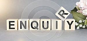 ENQUIRY word written on wood block. ENQUIRY text on table for