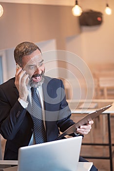 Enraged boss yelling at his employee over phone