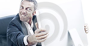 Enraged businessman with bulging eyes and teeth holding computer photo