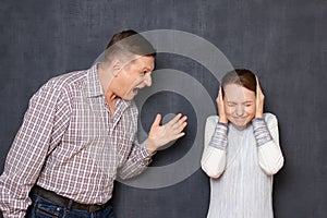 Enraged irritated man is scolding upset annoyed woman