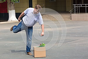 Enraged man kicks box of personal belongings after