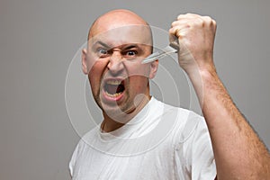 Enraged man with a knife in a murderous rage