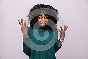 Enraged young curly african woman with hands up yelling isolated on white background